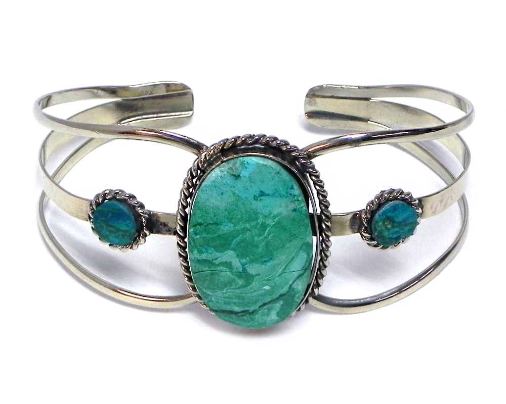 Handmade silver metal cuff bracelet with large oval-cut gemstone crystal cabochon centerpiece in teal green chrysocolla.