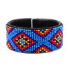 Handmade Native American inspired Czech glass seed bead black leather cuff bracelet with tribal fire diamond pattern design in light blue, blue, red, orange, and yellow color combination.