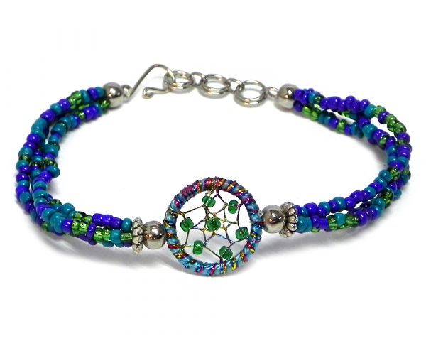 Handmade multicolored seed bead multi strand bracelet with round beaded sparkle thread dream catcher centerpiece in teal, turquoise blue, green, and indigo color combination.