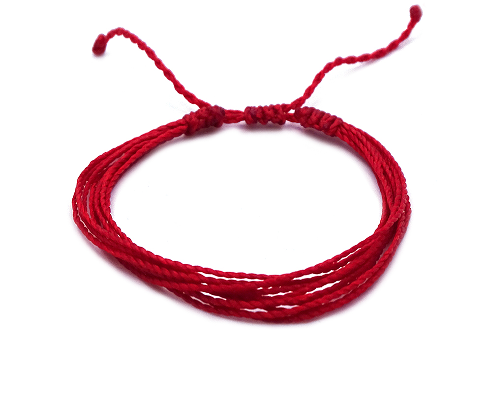 Handmade multi strand string pull tie bracelet in solid red color.