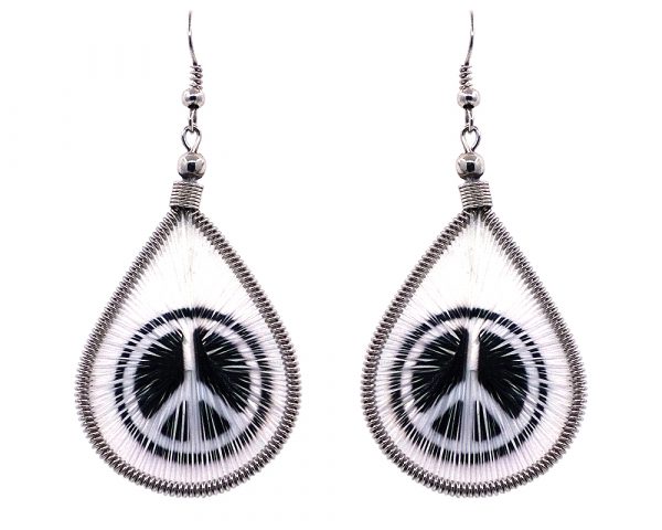 Teardrop-shaped thread dangle earrings with alpaca silver wire and peace sign graphic image in white and black color combination.