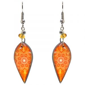 Ellipse-shaped New Age themed mandala graphic acrylic dangle earrings with beaded metal hooks in orange and white color combination.