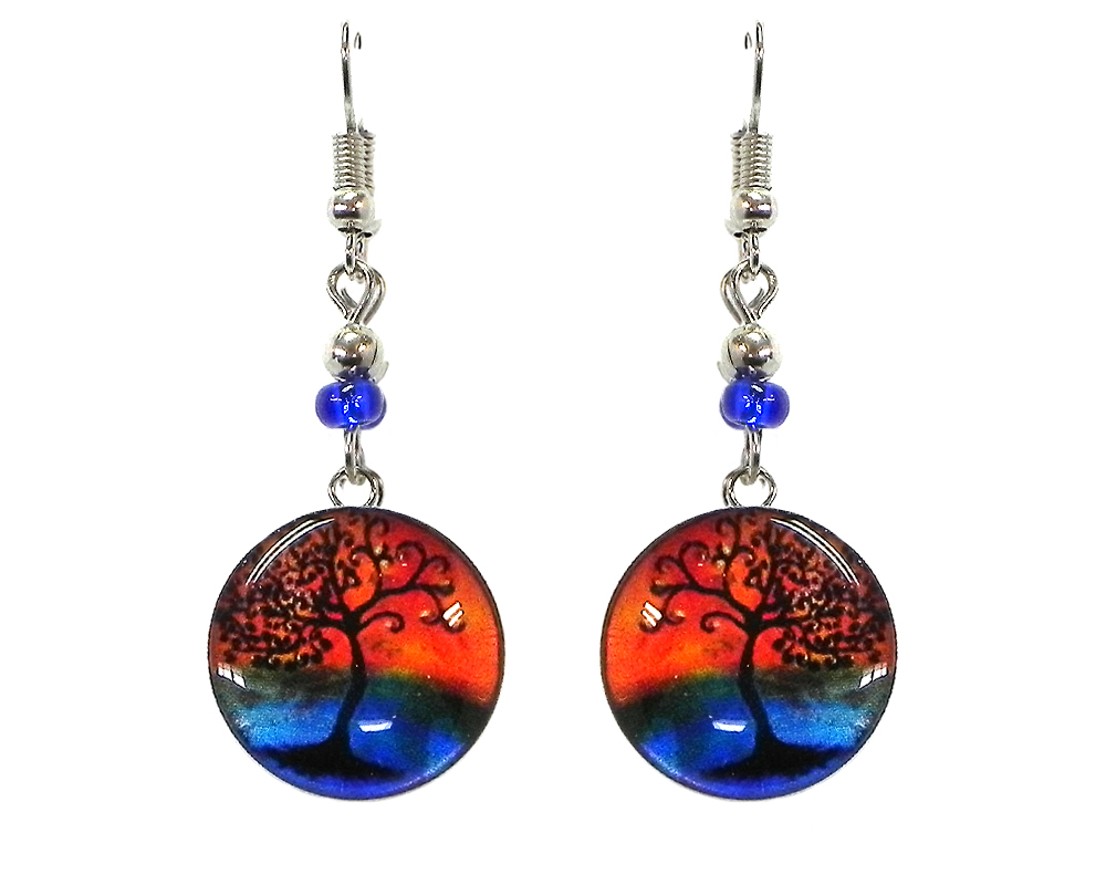 Round-shaped New Age themed sunset tree of life graphic acrylic dangle earrings with silver metal setting and beaded metal hooks in orange, blue and black color combination.