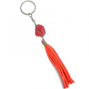 Handmade wire wrapped tumbled gemstone crystal with suede tassel dangle on silver metal key ring in salmon pink agate.