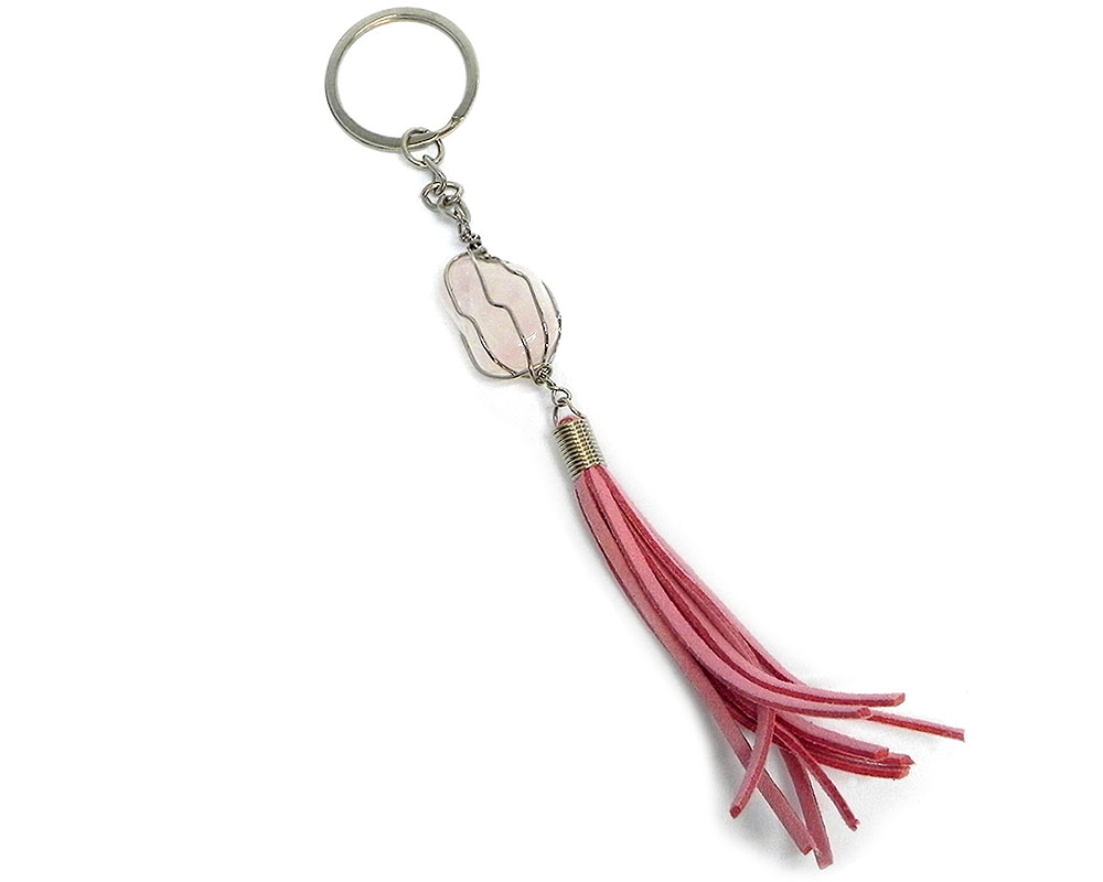 Handmade wire wrapped tumbled gemstone crystal with suede tassel dangle on silver metal key ring in pink color and light pink rose quartz.