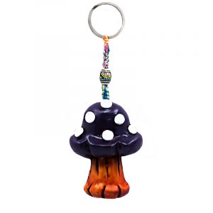 Handmade durepox resin figurine keychain of a toadstool Amanita magic mushroom in dark purple and white color combination.