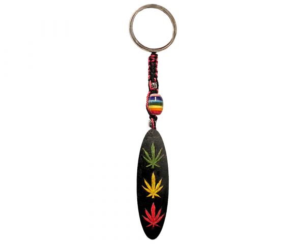 Handmade durepox resin figurine keychain of a black board with three cannabis leaves in Rasta colors.