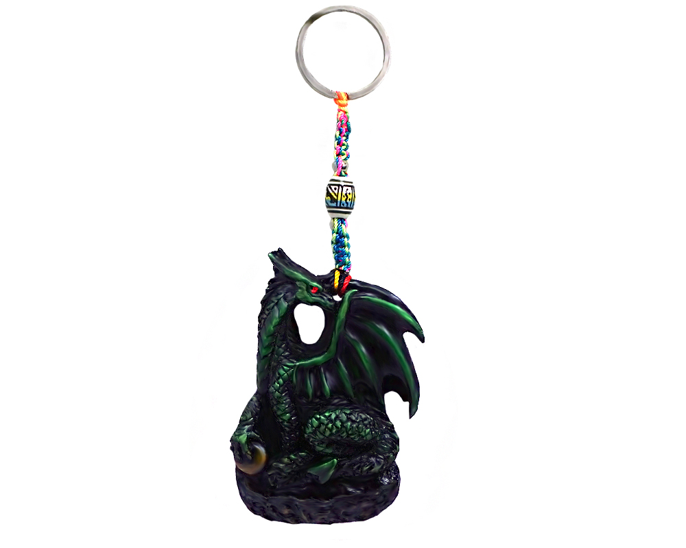 Handmade durepox resin figurine keychain of a green dragon holding a stone.