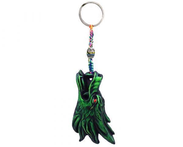 Handmade durepox resin figurine keychain of a green dragon head with red eyes.