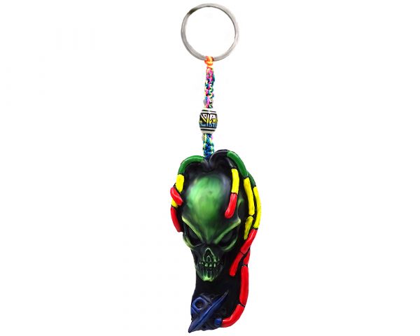 Handmade durepox resin figurine keychain of a green alien head with Rasta colors and a blue spaceship.