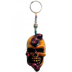 Handmade durepox resin figurine keychain of a beige skull with a slithering red snake.
