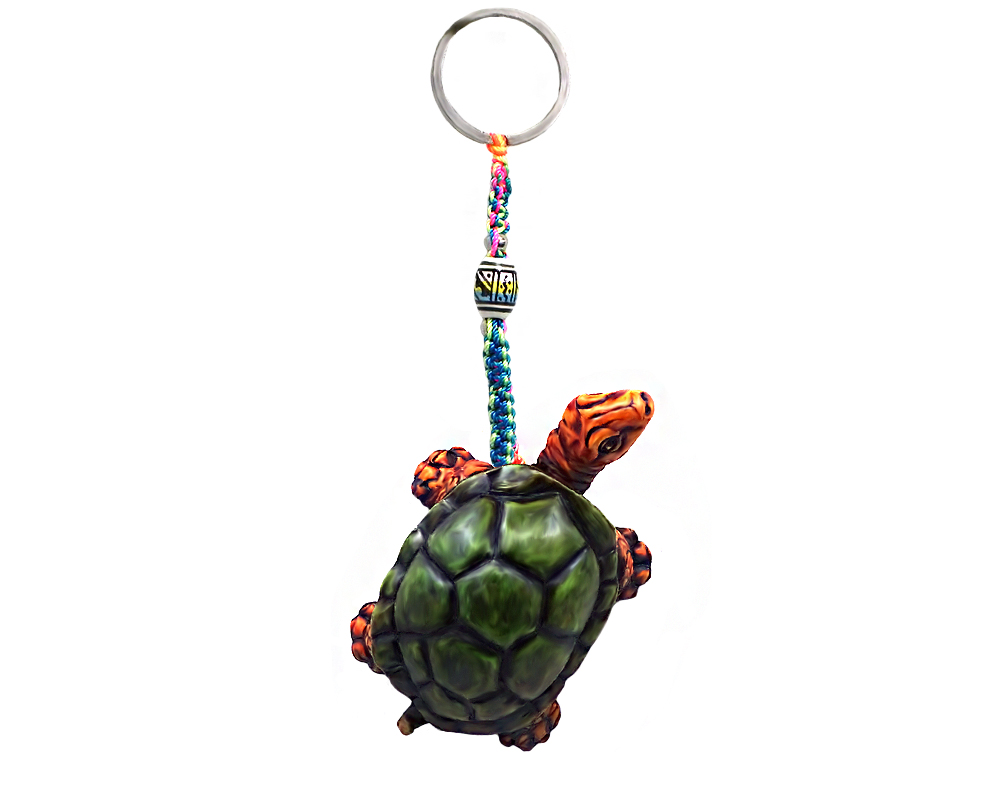 Handmade durepox resin figurine keychain of a green and brown land turtle.