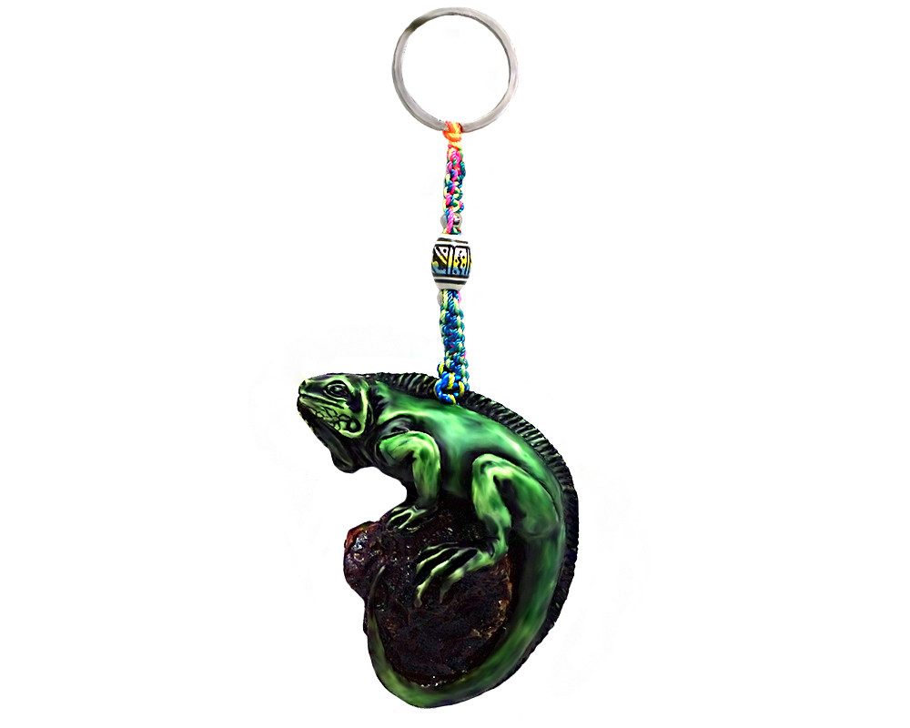 Handmade durepox resin figurine keychain of a green iguana on a rock.