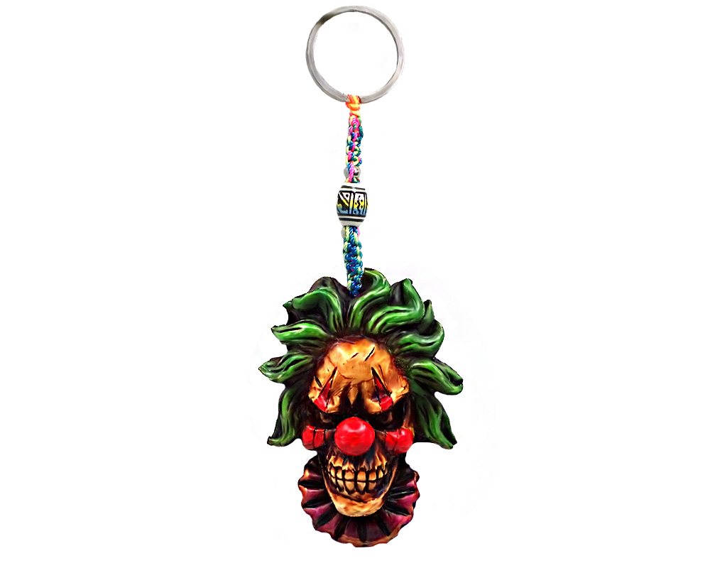 Handmade durepox resin figurine keychain of an evil clown head with a creepy smile and red nose.