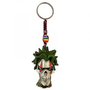 Handmade durepox resin figurine keychain of an evil clown skull with green hair and tie.