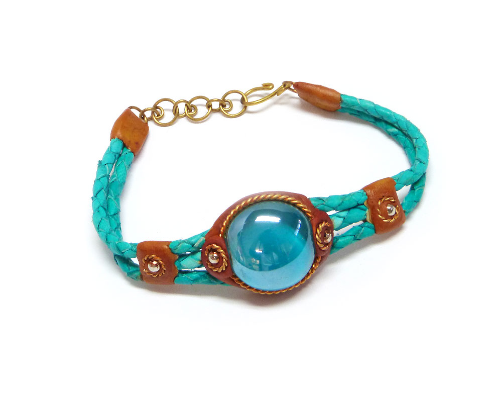 Handmade braided dyed leather bracelet with brown resin, gold-colored metal, and round-shaped glass bead centerpiece in teal green and turquoise blue color combination.