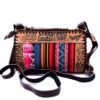 Handmade small Peruvian purse bag with authentic leather, acrylic wool, snap button and zipper closure, and adjustable strap in multicolored and brown.