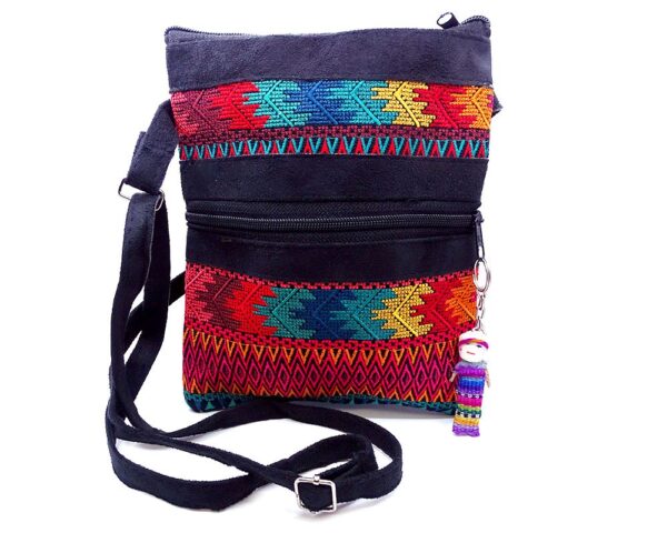 Handmade medium-sized slim rectangle-shaped crossbody purse bag with multicolored huipil embroidered tribal pattern design, black vegan leather suede, and worry doll keychain.