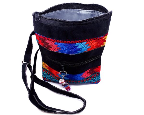 Handmade medium-sized slim rectangle-shaped crossbody purse bag with multicolored huipil embroidered tribal pattern design, black vegan leather suede, and worry doll keychain.