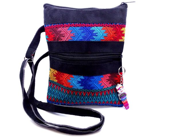 Handmade medium-sized slim rectangle-shaped crossbody purse bag with multicolored huipil embroidered tribal pattern design, black vegan leather suede, and worry doll keychain.