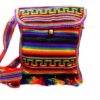 Handmade medium-sized slim square-shaped purse bag with multicolored tribal print striped pattern material (or manta Inca) and fringe in rainbow colors.