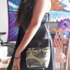 Medium-sized cushioned square-shaped purse bag with tree of life print pattern and coconut button and beads in beige and black color combination.