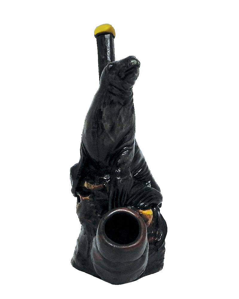 Handcrafted medium-sized tobacco smoking hand pipe of a gray seal sitting on a rock.