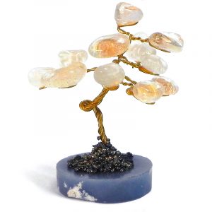 Handmade golden-colored metal wire and tumbled gemstone clear quartz crystal tree of life table ornament with crushed pyrite and a round stone base.