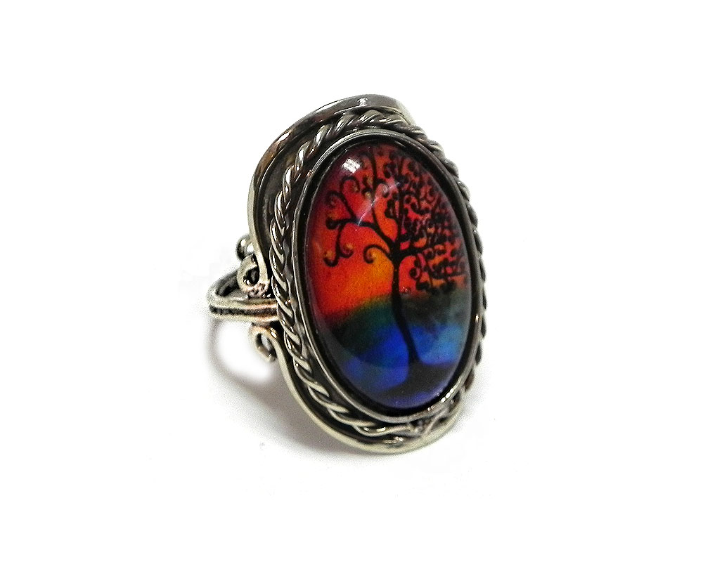 Handmade oval-shaped acrylic New Age themed sunset tree of life graphic design on alpaca silver metal ring with rope edge border in orange, blue, and black color combination.