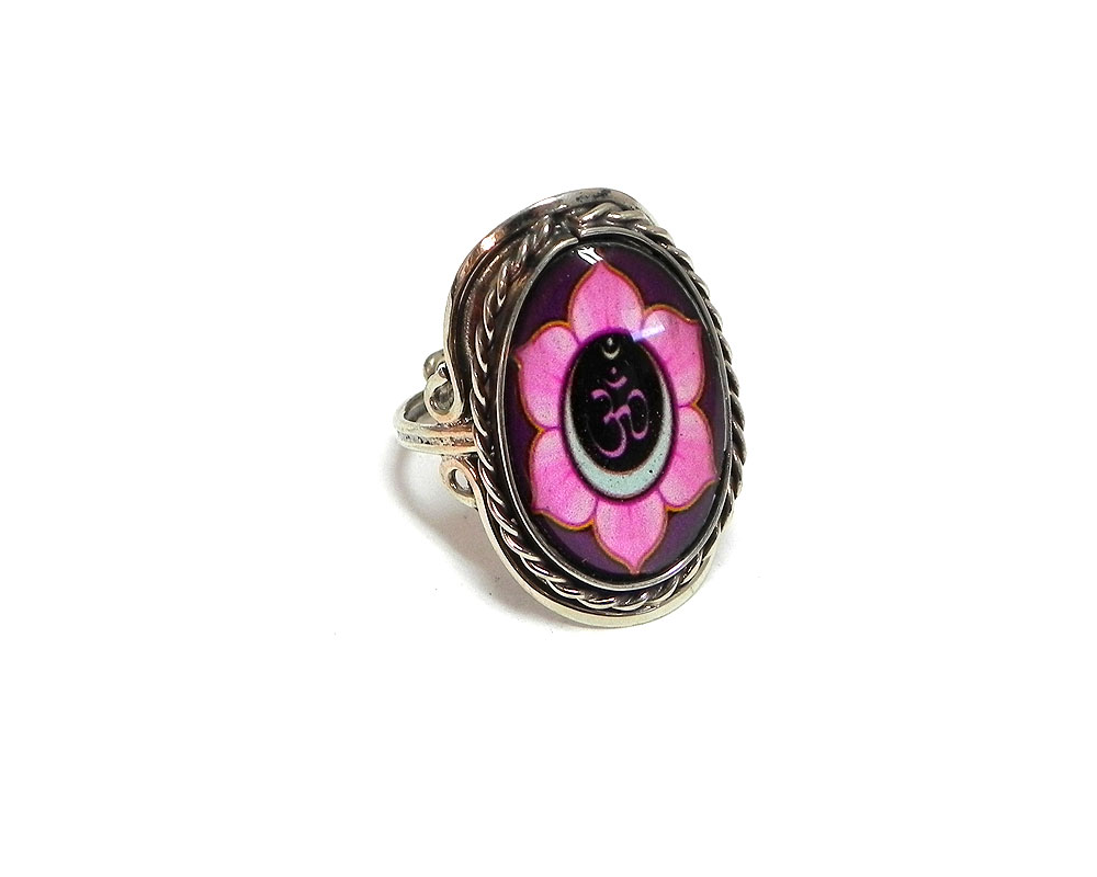 Handmade oval-shaped acrylic New Age themed floral om sign graphic design on alpaca silver metal ring with rope edge border in pink, burgundy, black, and white color combination.