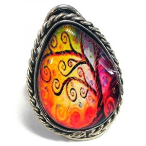 Handmade teardrop-shaped acrylic New Age themed tree of life graphic design on alpaca silver metal ring with rope edge border in orange, golden yellow, hot pink, and brown color combination.