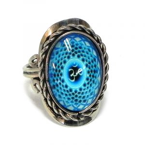 Handmade small oval-shaped acrylic New Age themed om sign graphic design on alpaca silver metal ring with rope edge border in turquoise, light blue, and black color combination.