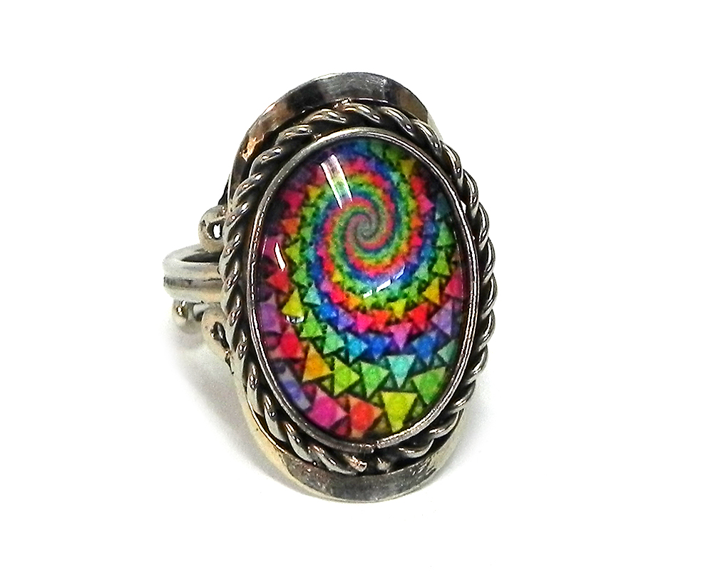Handmade small oval-shaped acrylic New Age themed psychedelic geometric spiral graphic design on alpaca silver metal ring with rope edge border in black and rainbow color combination.