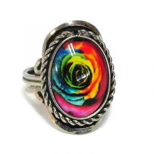 Handmade small oval-shaped acrylic New Age themed rose flower graphic design on alpaca silver metal ring with rope edge border in rainbow color combination.