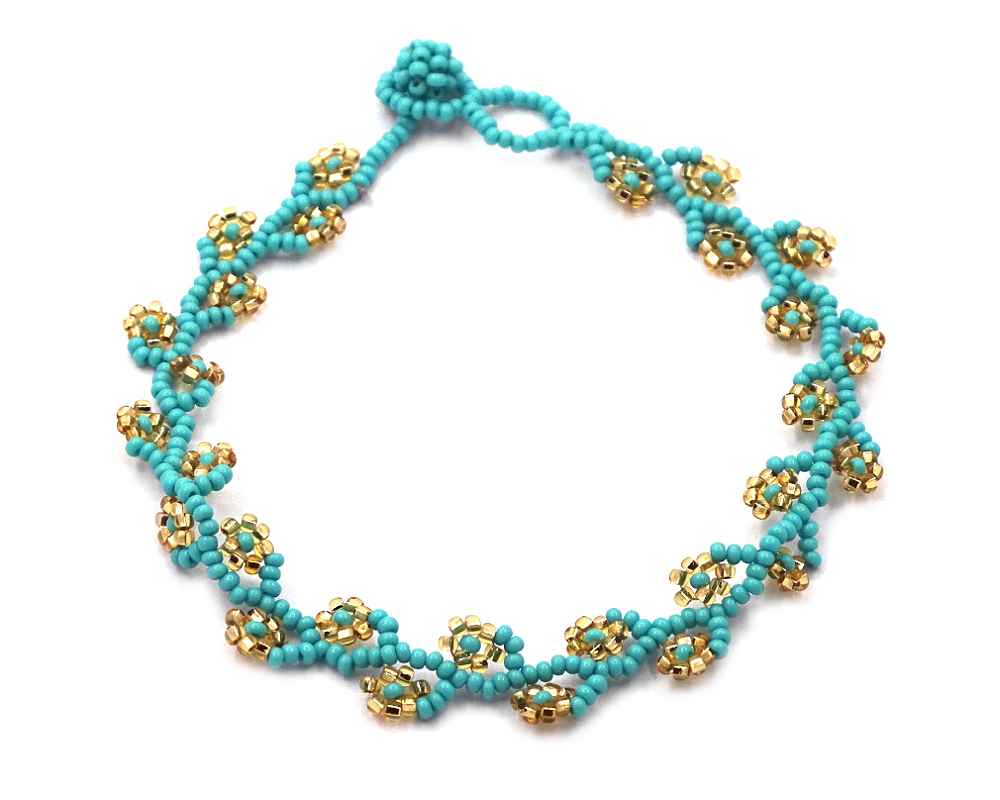 Handmade Czech glass seed bead floral vine anklet with beaded flowers in turquoise mint and gold color combination.