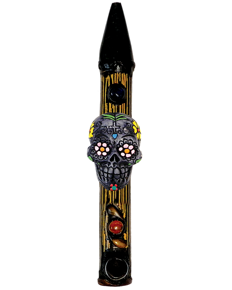 Handcrafted tobacco smoking natural bamboo wooden peace pipe of a gray Day of the Dead sugar skull with multicolored floral designs.