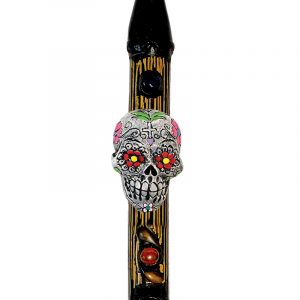 Handcrafted tobacco smoking natural bamboo wooden peace pipe of a white Day of the Dead sugar skull with multicolored floral designs.