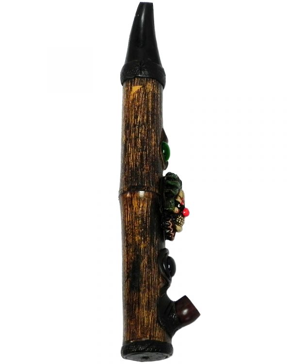 Handcrafted tobacco smoking natural bamboo wooden peace pipe of an evil clown head with a creepy smile and red nose.