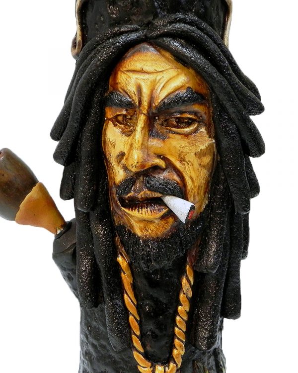 Handcrafted tobacco smoking water pipe of smoking Bob wearing green and gold peace sign necklace and decorative leaves.