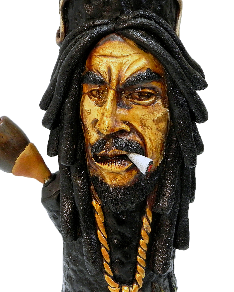 Handcrafted tobacco smoking water pipe of smoking Bob wearing green and gold peace sign necklace and decorative leaves.