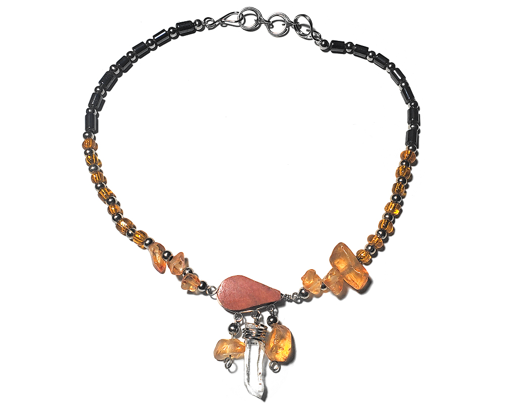 Handmade hematite and seed bead alpaca silver metal chain anklet with teardrop-cut orange jasper stone cabochon, natural clear quartz crystal point, chip stones, and metal dangles in orange color.