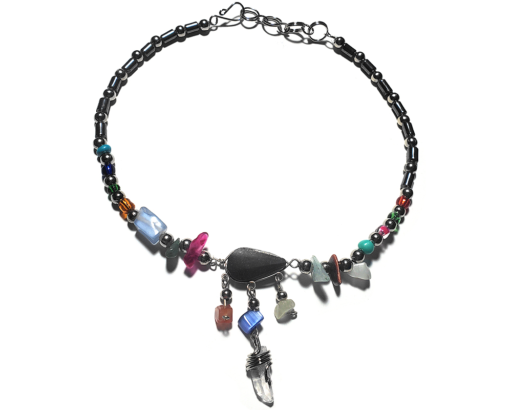 Handmade hematite and seed bead alpaca silver metal chain anklet with teardrop-cut black onyx stone cabochon, natural clear quartz crystal point, chip stones, and metal dangles in multicolored color.