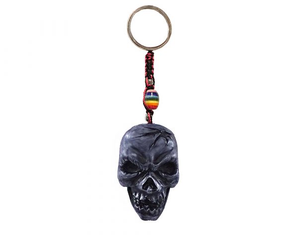Handmade durepox resin figurine keychain of a gray cracked skull.