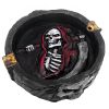 Handcrafted round flat incense holder ash tray with image of a hooded grim reaper death skull holding scythe in red, white, gray, gold, and black color combination.