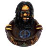 Handcrafted round incense holder ash tray with a peace sign and 3D figurine of a smoking man with dreads and sunglasses in black, brown, tan, gold, red, green, yellow, and white color combination.