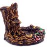 Handcrafted round incense holder ash tray with a floral design and a 3D figurine of a tree man in brown, black, gold, green, and multicolored color combination.