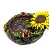 Handcrafted round incense holder ash tray with floral design and a 3D figurine of a sunflower with leaves in yellow, brown, black, gold, green, and multicolored color combination.