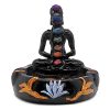 Handcrafted round incense holder ash tray with a gold om sign, lotus design, and a black 3D figurine of a meditating body with 7 chakra rainbow-colored tumbled gemstone crystals.
