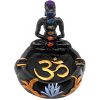 Handcrafted round incense holder ash tray with a gold om sign, lotus design, and a black 3D figurine of a meditating body with 7 chakra rainbow-colored tumbled gemstone crystals.