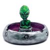 Handcrafted round incense holder ash tray in a flying saucer shape with a galaxy design and a 3D figurine of an alien in green, silver, dark purple, red, white, and black color combination.